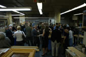 Guests gather in the frame restoration studio during a tour